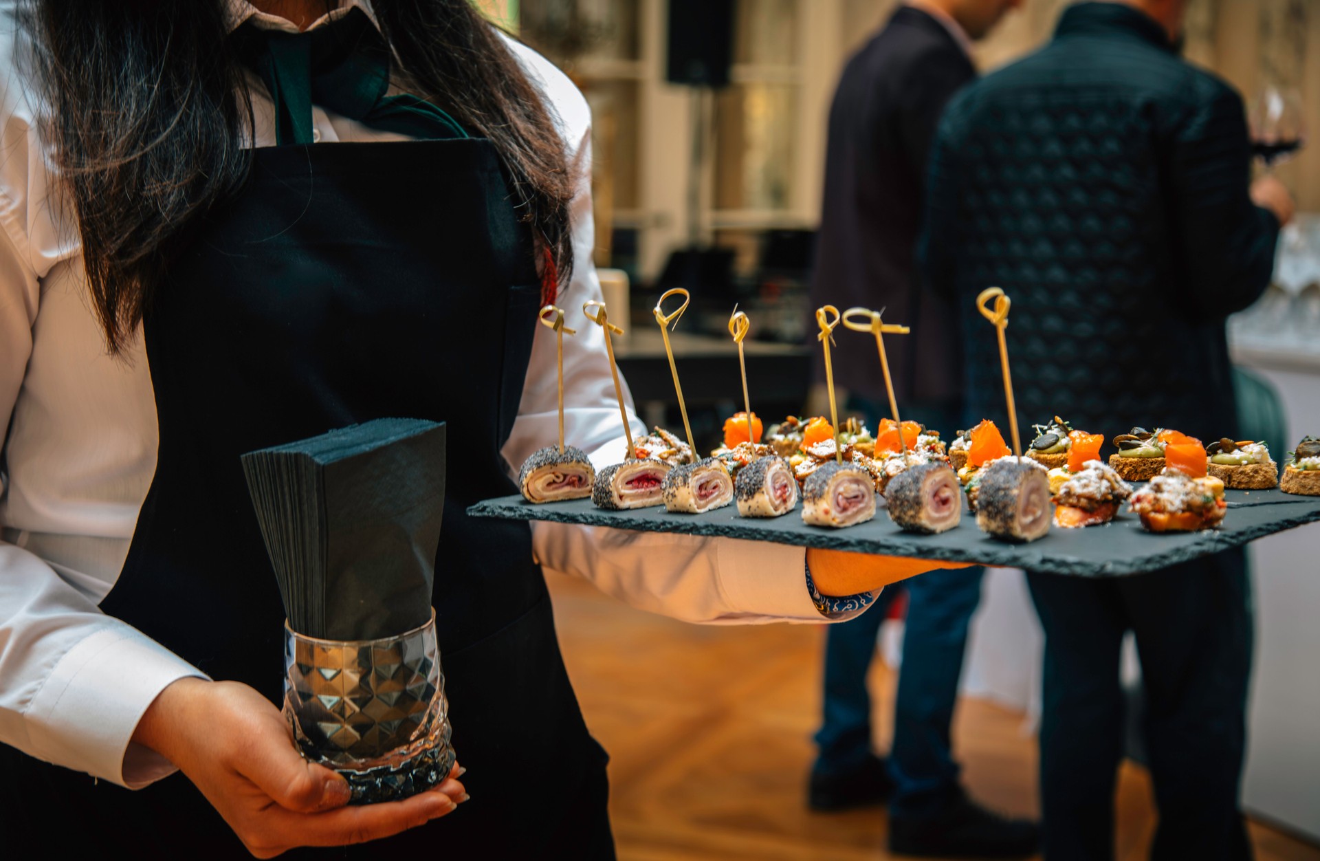 Waitress Serving Elegant Appetizers on a Slate Tray